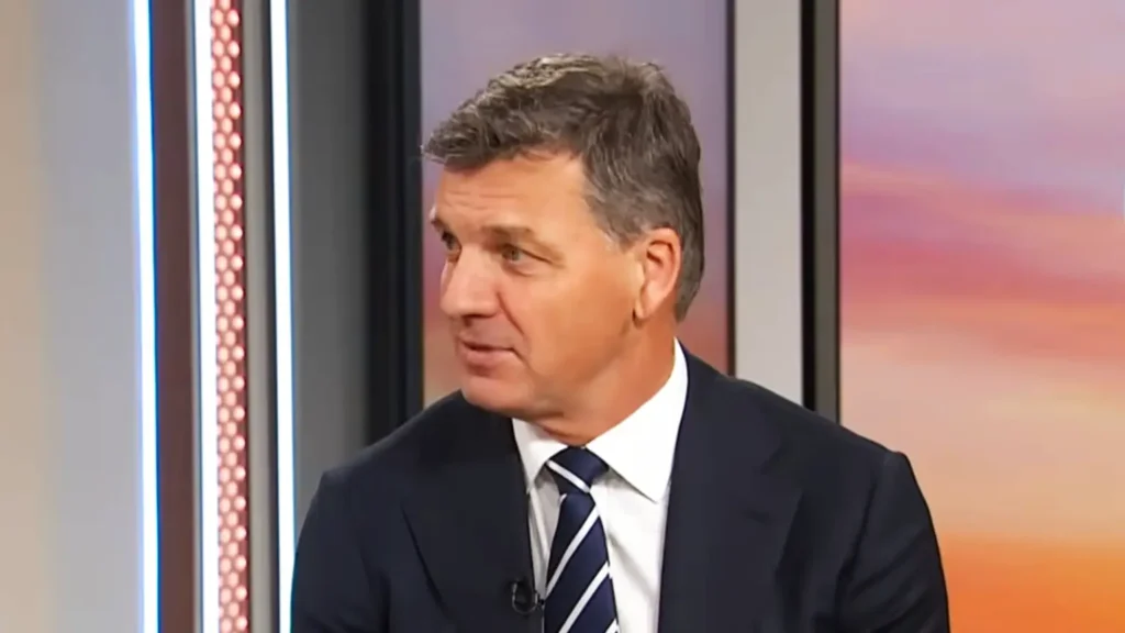 Angus Taylor gestures mid-answer during a television interview